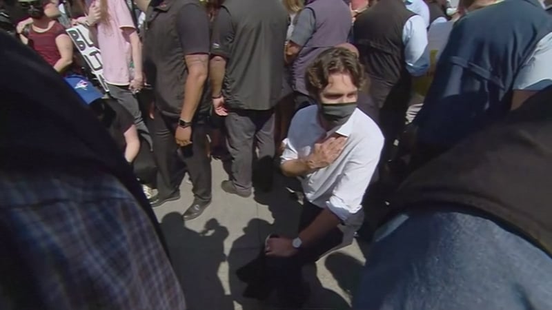 Protesters chanted "Stand up to Trump" to the prime minister during the "No justice = No peace" rally shortly after it began