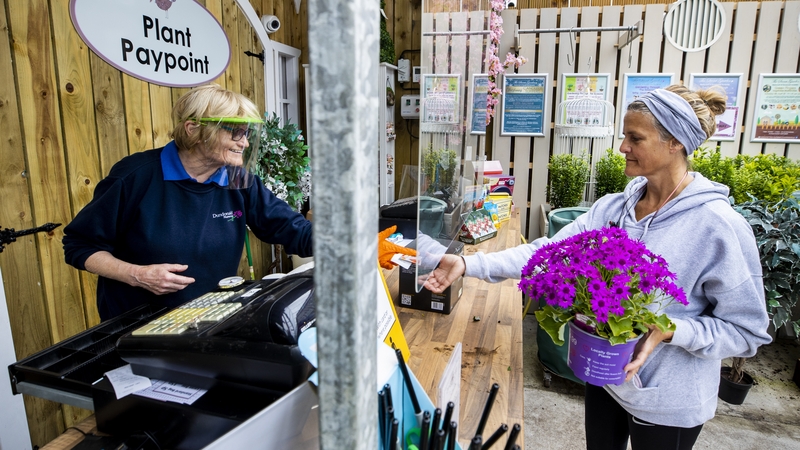Customer Joanne McConville buying flowers at Dundonald Nurseries in Belfast last month when garden centres in Northern Ireland reopened