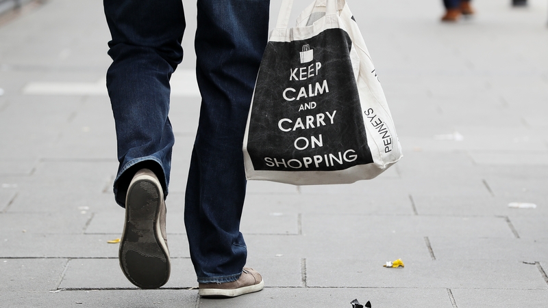 A man carries a shopping bag in Dublin