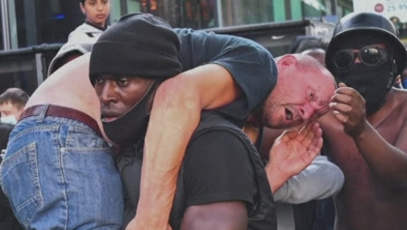 Patrick Hutchinson lifted the unnamed man to safety (Pic Reuters)