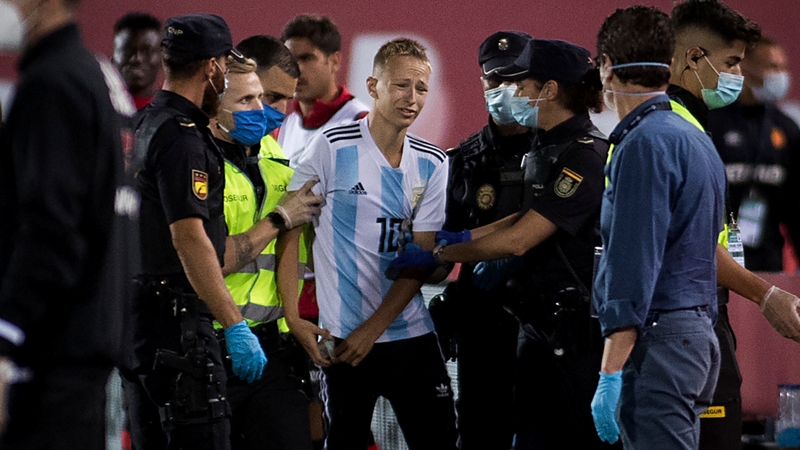 The Real Mallorca-Barcelona interloper is escorted away from the field of play