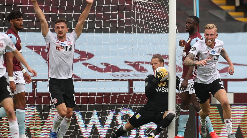 Sheffield United's players react as Aston Villa's goalkeeper Orjan Nyland (C) appears to carry the ball over the line