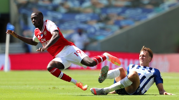 Nicolas Pepe of Arsenal is challenged by Brighton's Dan Burn