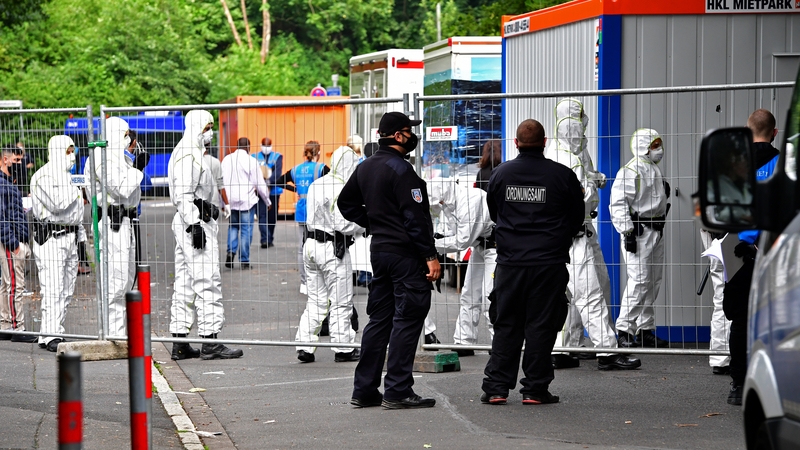 Police officers wearing full protective suits prepare to enter a tower block in Goettingen on Friday