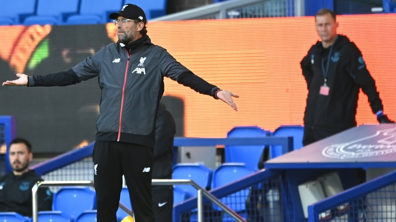 Jurgen Klopp looks on as Everton coach Duncan Ferguson keeps his social distance from the Liverpool boss