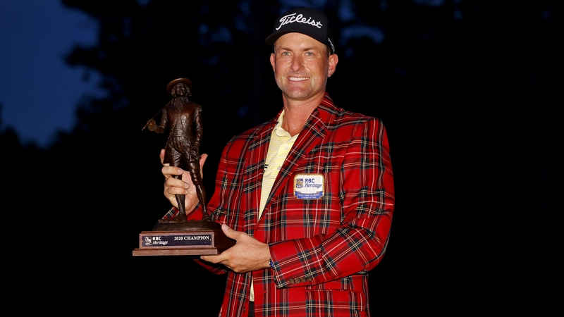 Webb Simpson of the United States celebrates with the trophy and tartan jacket