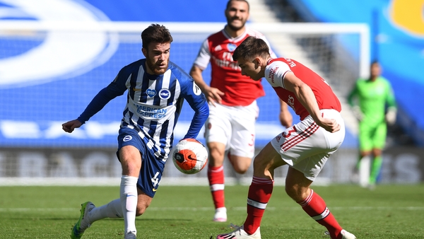 Aaron Connolly challenged by Arsenal's Kieran Tierney