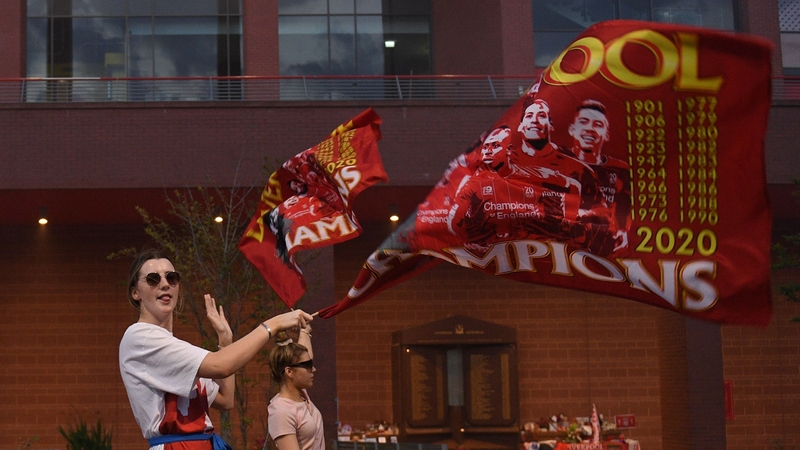 Fans celebrate Liverpool winning the title outside Anfield