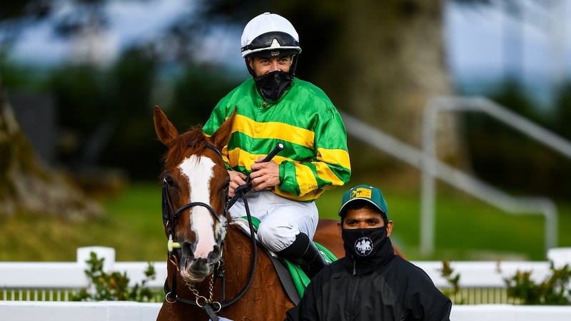 Wayne Lordan, on Music To My Ears, is led to the winner's enclosure after taking the TRM Fillies Handicap
