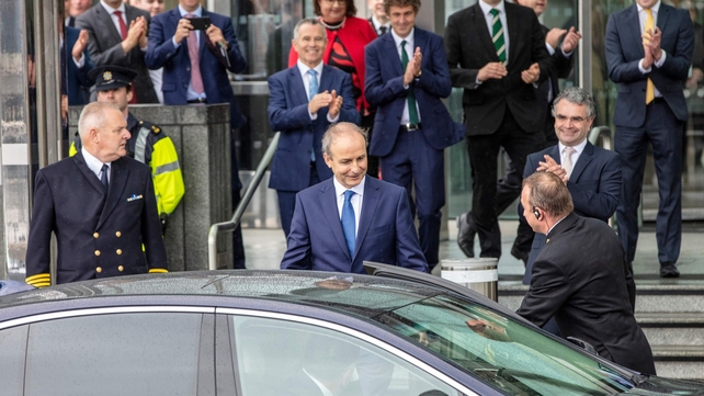 Taoiseach-elect Micheál Martin is applauded by party colleagues as he leaves the Convention Centre