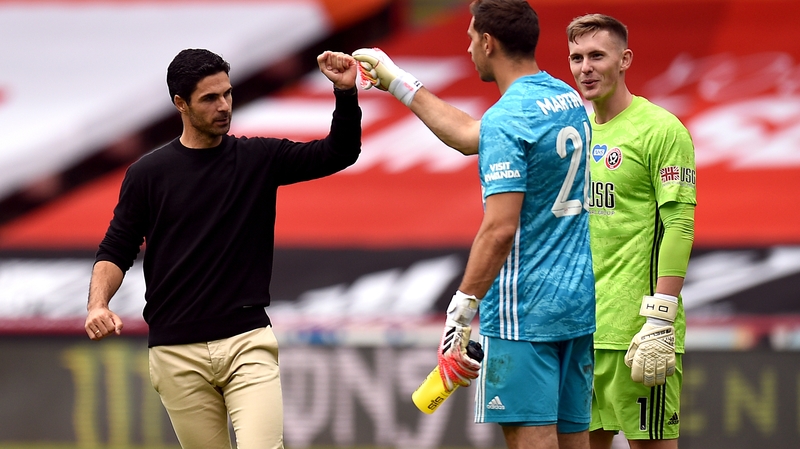 Arsenal manager Mikel Arteta and goalkeeper Emiliano Martinez bump fists after their FA Cup win