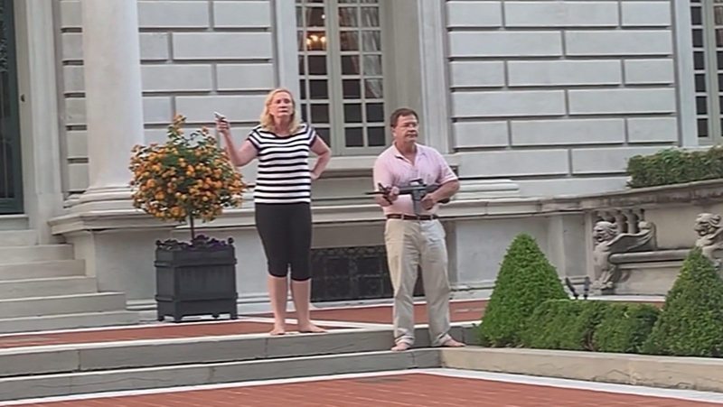Patricia and Mark McCloskey pointed guns as protesters walked by their home