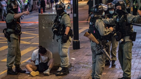 Riot police arrest a man during protests in the city