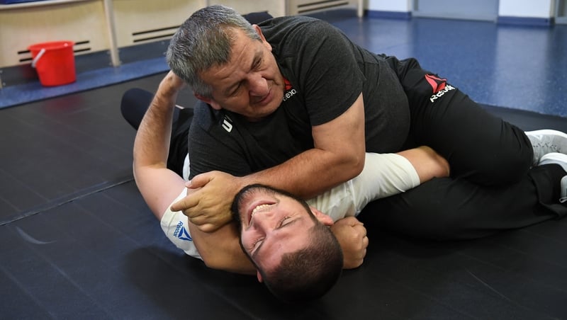 UFC lightweight champion Khabib Nurmagomedov grapples with his father Abdulmanap Nurmagomedov backstage during the UFC Fight Night event in Moscow last November