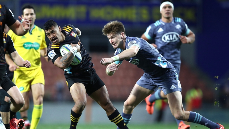 Te Toiroa Tahuriorangi of the Chiefs is tackled by Jordie Barrett of the Hurricanes