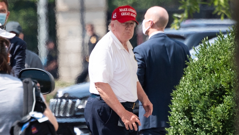 US President Donald Trump walks into the White House in Washington after a day playing golf