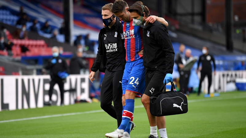 Gary Cahill hobbles off with some assistance after damaging his hamstring against Chelsea