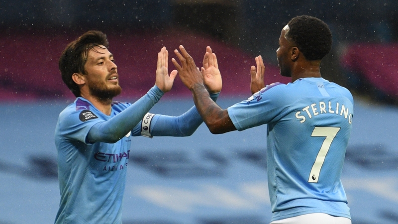 Raheem Sterling (R) high fives midfielder David Silva (L) after scoring City's fifth goal