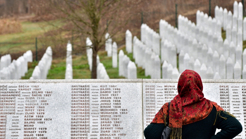 A woman stands at a memorial to those who were killed at Srebrenica