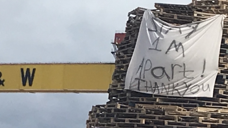 A sheet with the message 'Stay 1m apart thank you' on a bonfire pile in Belfast as Orange Order asked for no bonfires to be lit due to coronavirus
