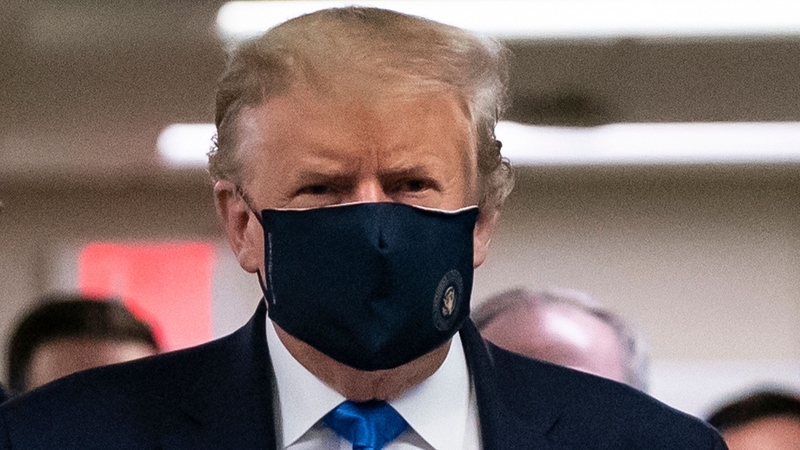 US President Donald Trump wears a mask as he visits Walter Reed National Military Medical Centre in Bethesda, Maryland