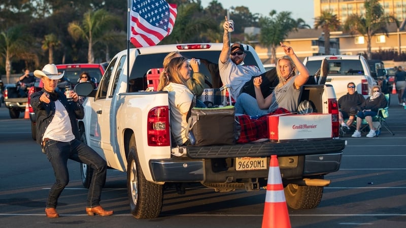 People attending a drive-in live music event at Ventura, California, where a new shutdown is coming into force
