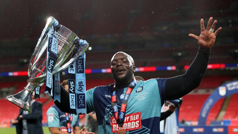 Akinfenwa celebrates with the trophy after the Sky Bet League One play-off final