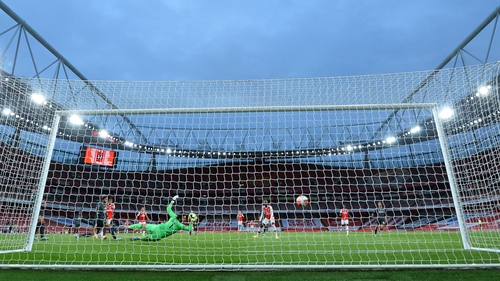 Alisson dives in vain as Arsenal's Reiss Nelson scores his side's second goal
