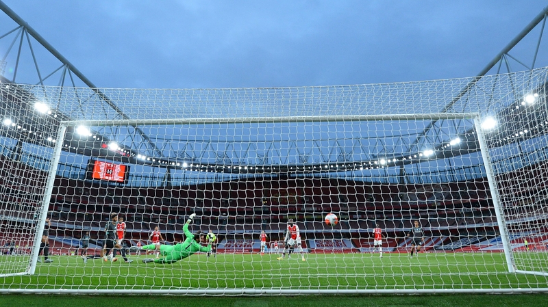 Alisson dives in vain as Arsenal's Reiss Nelson scores his side's second goal