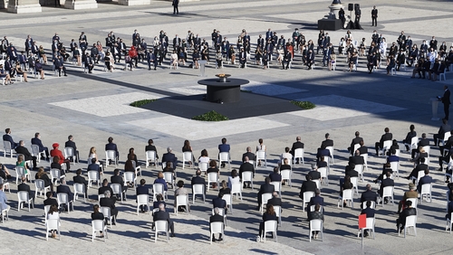 Participants lay flowers during the state tribute to the victims of the coronavirus at the Royal Palace in Madrid, Spain