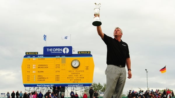 Darren Clarke holds the Claret Jug aloft