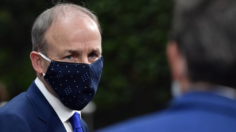 Taoiseach Micheál Martin arrives at the summit wearing a mask