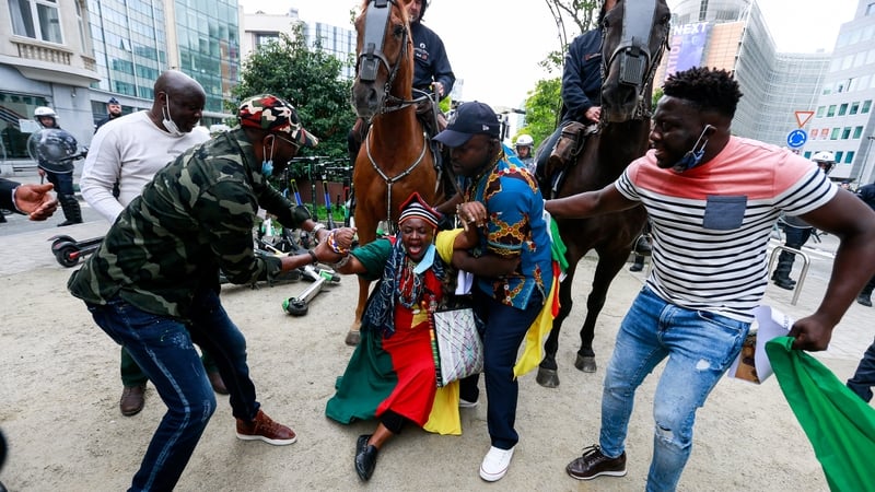 People attend a protest outside the European Council headquarters in Brussels