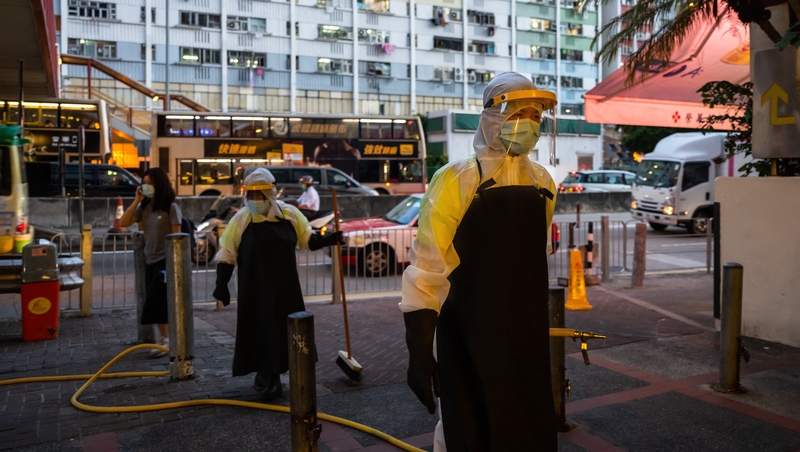 Food and Environmental Hygiene Department contractors clean and disinfect a market in Hong Kong