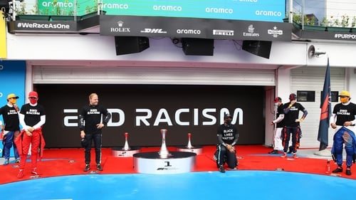 Lewis Hamilton takes a knee in support of the Black Lives Matter movement