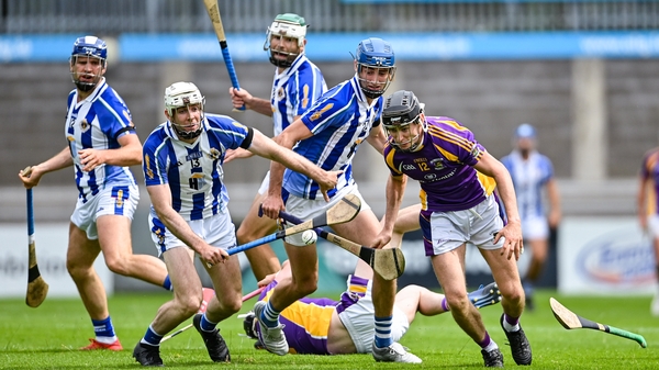 Coalán Conway of Kilmacud Crokes wheels away from Niall Ryan and Paddy Dunleavy