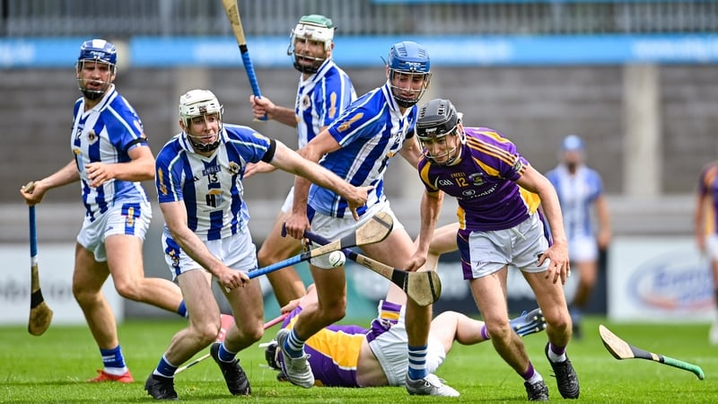 Coalán Conway of Kilmacud Crokes wheels away from Niall Ryan and Paddy Dunleavy