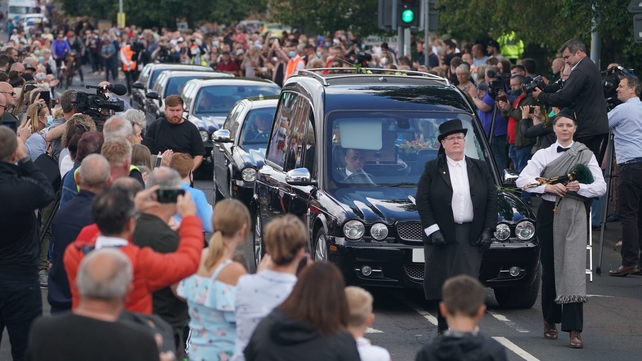 Streets thronged as the funeral procession passes