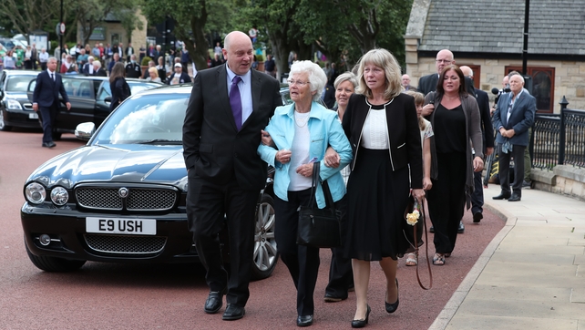 Charlton's wife Pat (centre) being helped into the funeral at the West Road Crematorium in Newcastle