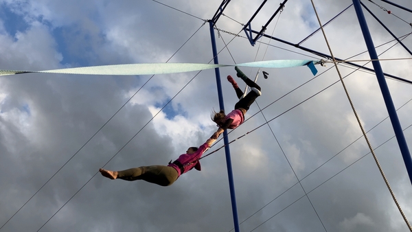 Mariana Rampazzo with a student at her outdoor flying trapeze school