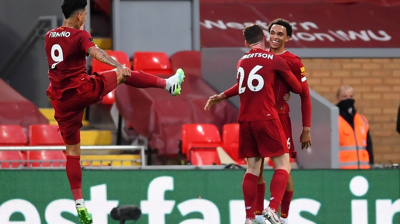 Trent Alexander-Arnold (R) celebrates scoring with team-mates Andrew Robertson (centre) and Roberto Firmino