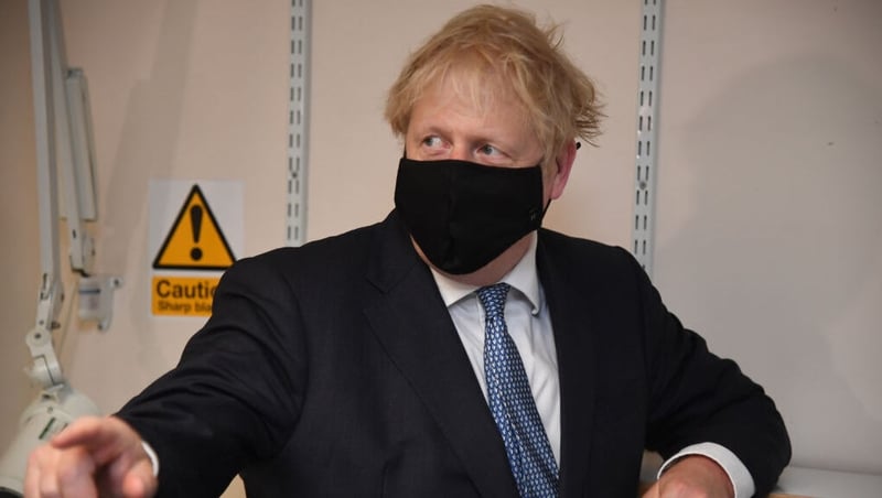 Boris Johnson wearing a face covering during a visit to a medical centre in London