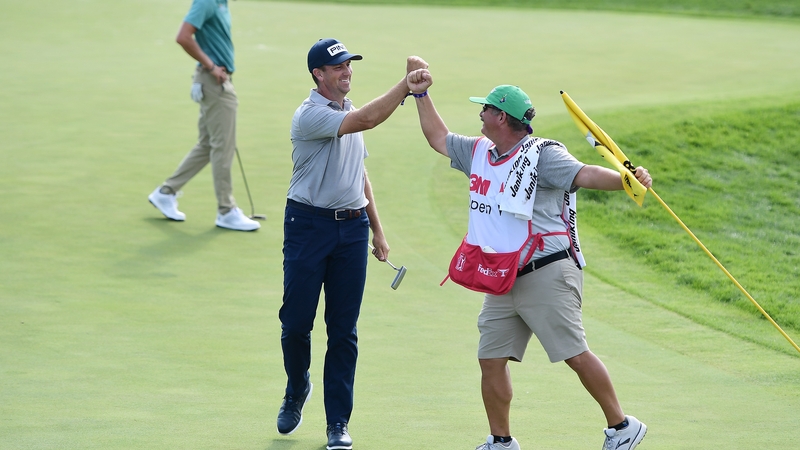 Thompson celebrates with his caddy Damian Lopez