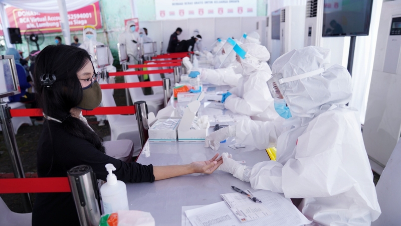 Health workers take samples at a Covid-19 rapid test facility in Jakarta, Indonesia
