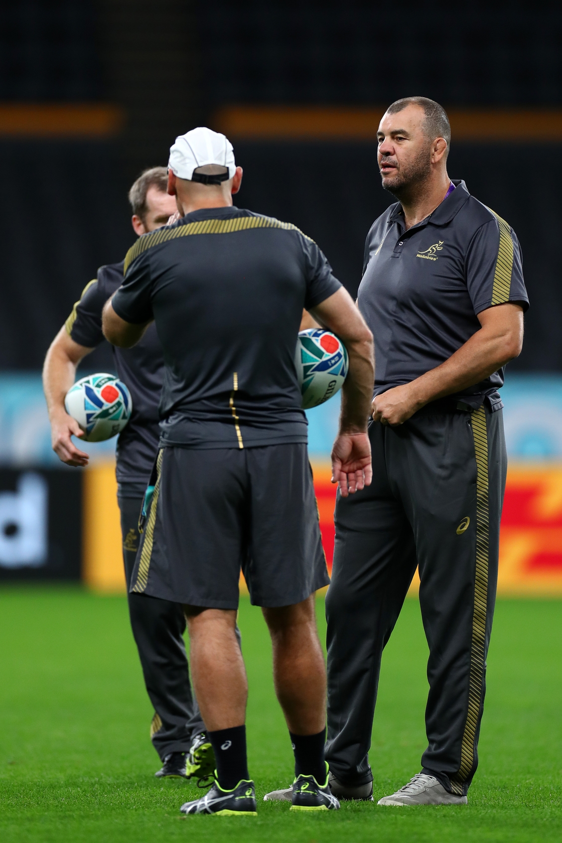 Michael Cheika (r) at the 2019 World Cup with his coaches Nathan Grey and Shaun Berne