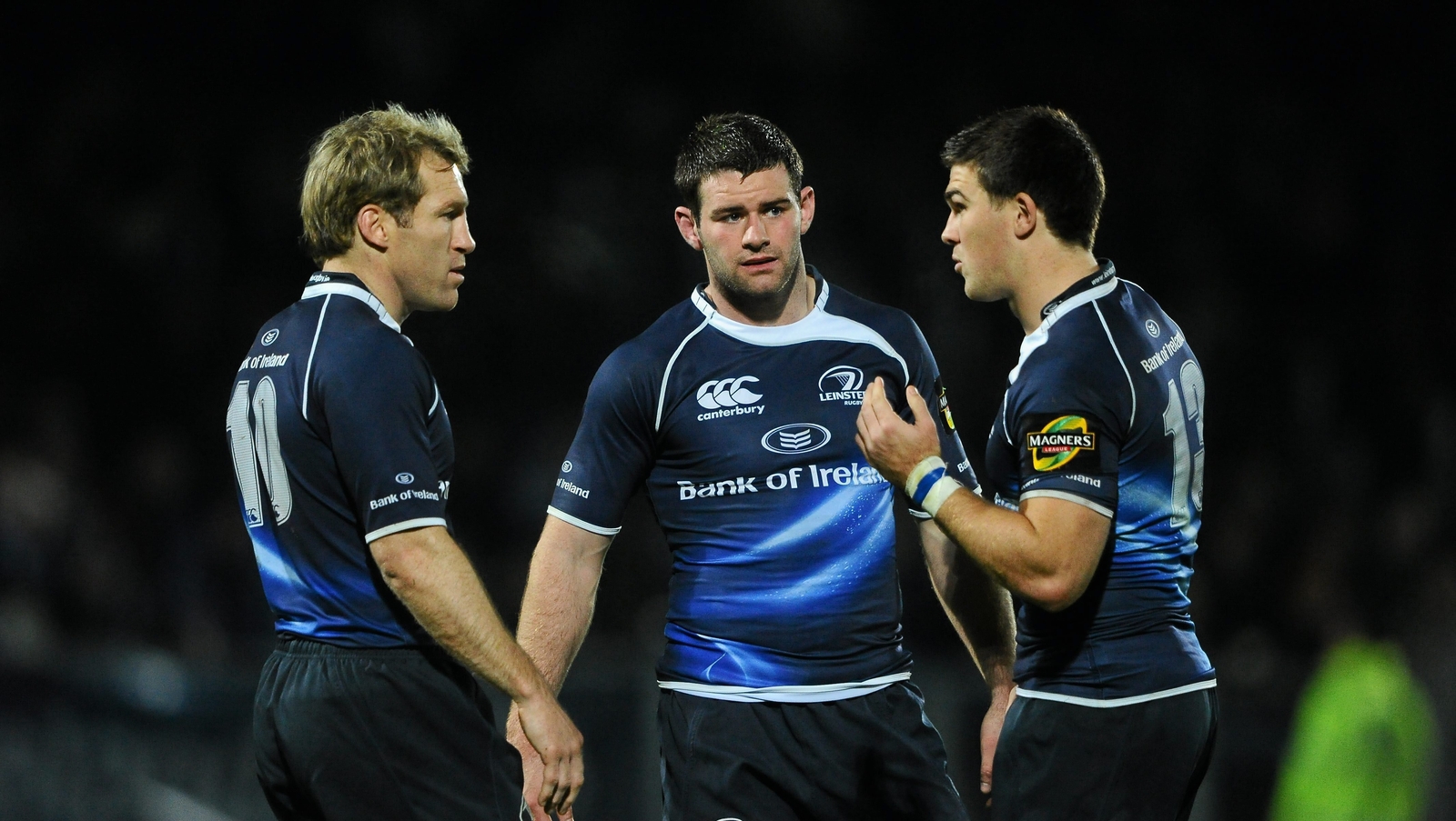 Shaun Berne, Fergus McFadden and Eoin O'Malley in conversation during a Leinster match in 2010
