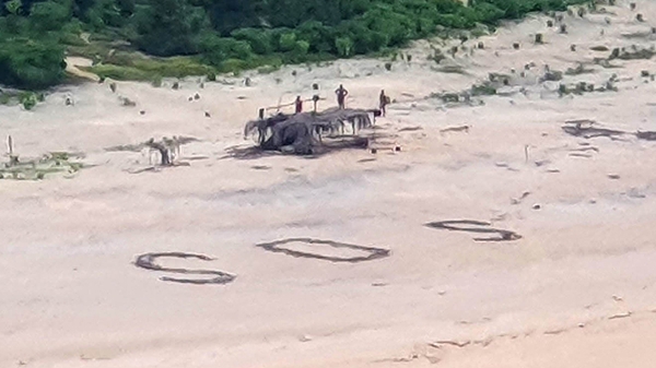 Australian and US warplanes spotted a giant "SOS" the men had scrawled on the beach (Photo courtesy of Australian Defence Force)