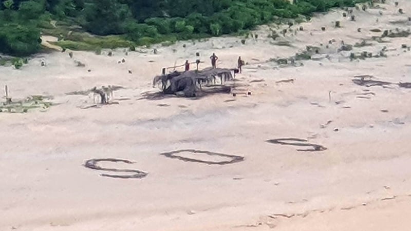 Australian and US warplanes spotted a giant "SOS" the men had scrawled on the beach (Photo courtesy of Australian Defence Force)