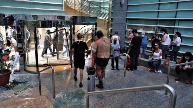 The damaged entrance of Najjar Hospital in Al-Hamra area as people injured in the blast arrive for treatment
