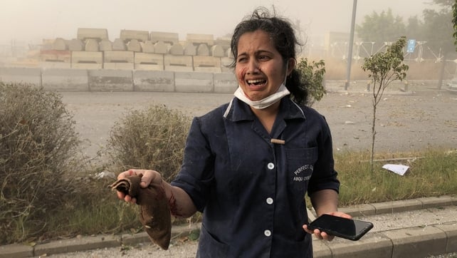 A migrant worker reacts in shock; some residents thought an earthquake had struck